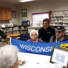 Tony Kurtz, Becky and Wayne Blinston with the gift of the WI flag